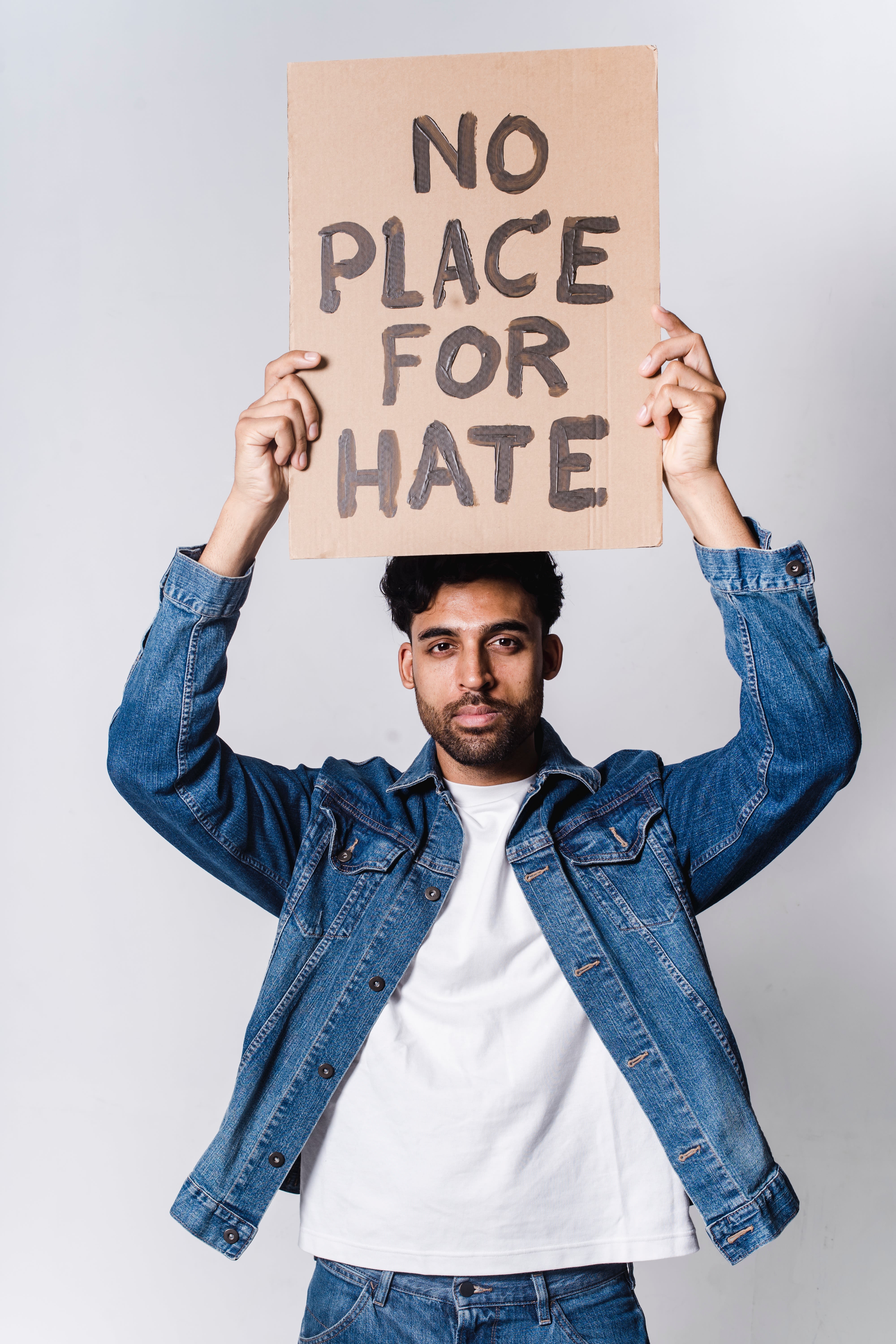 Man holding sign saying no place for hate