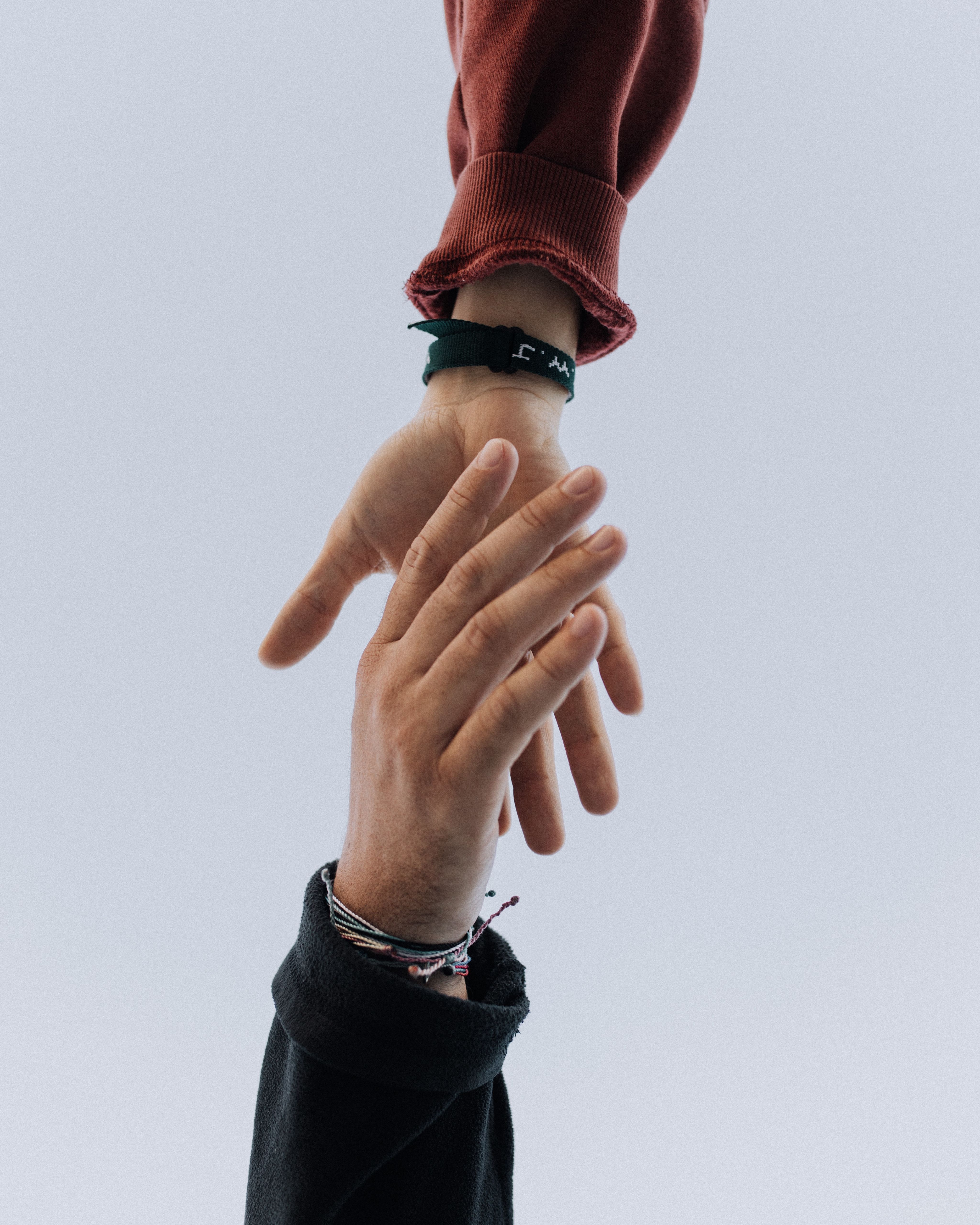 View of two people's hands